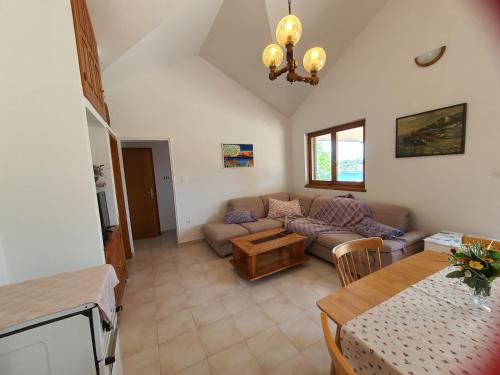 ein Wohnzimmer mit einem Sofa und einem Tisch in der Unterkunft Mendula Apartment in Rogač