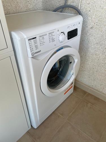 a white washing machine in a kitchen next to a counter at Flamenco Ambar Luxury Apartment 15 Planta in Calpe