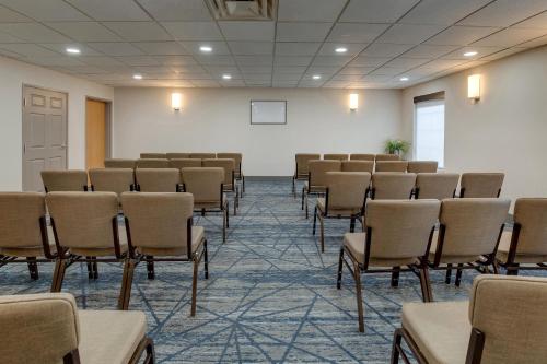 an empty room with chairs and a white wall at Holiday Inn Express I-95 Capitol Beltway - Largo by IHG in Largo