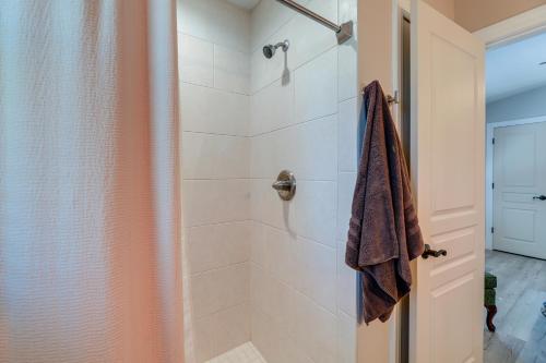a bathroom with a shower with a glass door at Lovely Morehead City Home with Fire Pit and Gas Grill in Morehead City