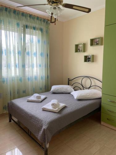 a bedroom with a bed with two towels on it at Seaside House in Karianí