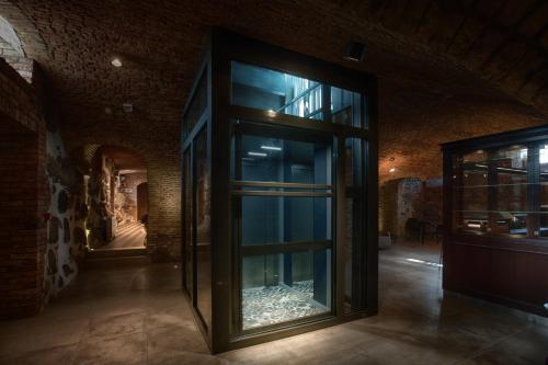 a room with a glass door in a building at Relais & Châteaux Hotel Quadrille - Adults Only in Gdynia