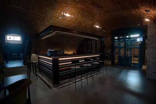 a bar in a room with chairs and a brick wall at Relais & Châteaux Hotel Quadrille - Adults Only in Gdynia