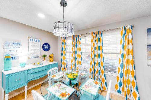 a dining room with a blue table and chairs at Pretty in Perdido Key in Perdido Key