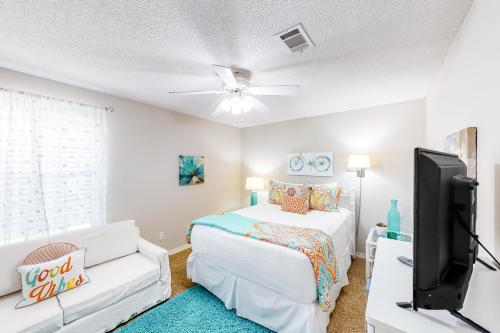 a bedroom with a bed and a flat screen tv at Pretty in Perdido Key in Perdido Key