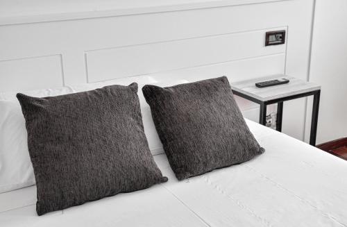 Un pat sau paturi într-o cameră la Hotel Chips Ferrol