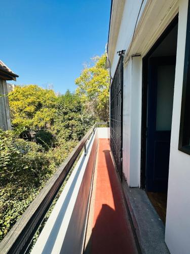 a balcony of a building with a bench on it at MAKTVB Europa - Hostal Boutique in Santiago