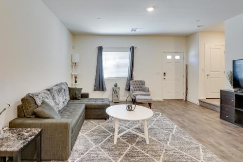 a living room with a couch and a table at Inviting Henderson Townhome with Community Pool! in Las Vegas