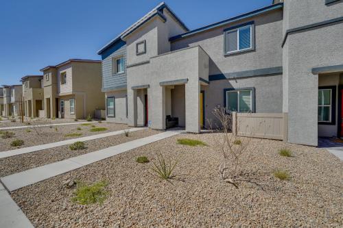 a row of apartment buildings with a courtyard at Inviting Henderson Townhome with Community Pool! in Las Vegas