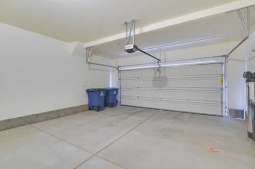 an empty garage with a door and a tile floor at Inviting Henderson Townhome with Community Pool! in Las Vegas