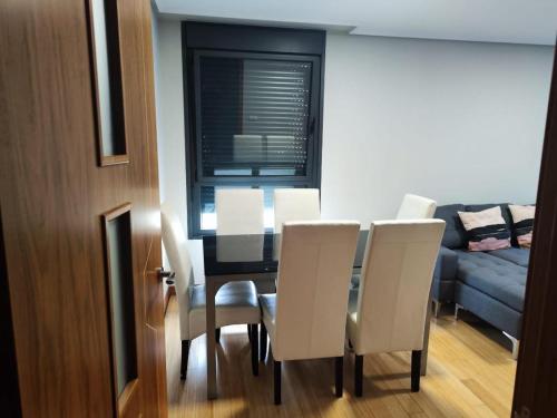 une salle à manger avec une table et des chaises blanches dans l'établissement TORRES DE MONTENUÑO, à Oviedo