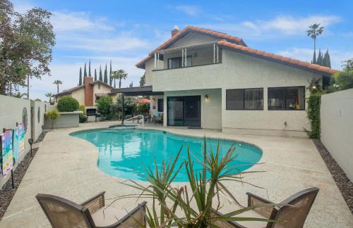 a swimming pool in front of a house at Peaceful Private Retreat In The Heart Of Town in Redlands