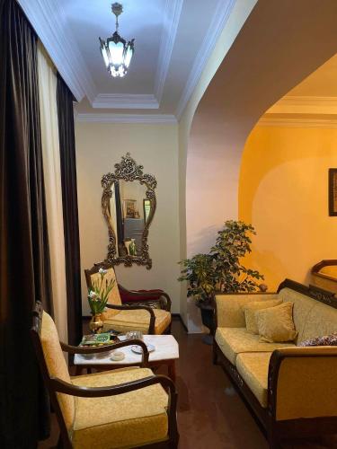 a living room with a couch and a mirror at Melson in Batumi