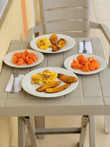 a table with three plates of food on it at Hotel el Turista in Florencia