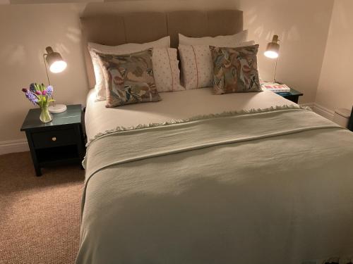 a bedroom with a large white bed with pillows at 4 Tom's Lane in Bantry