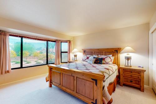 a bedroom with a large bed and a large window at Sun City Vistoso in Oro Valley