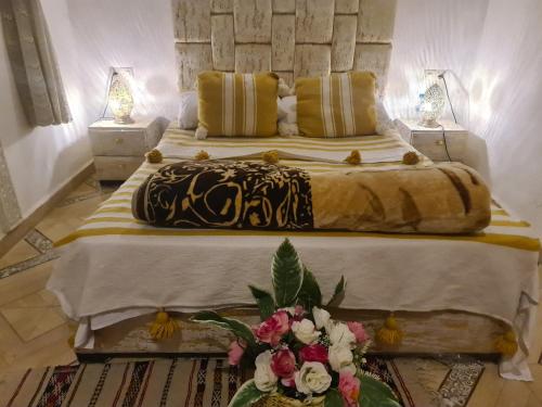 a bedroom with a large bed with flowers on it at Riad bel kayed in Fez