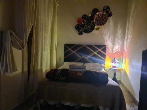 a bedroom with a bed with a blue head board at Riad bel kayed in Fès