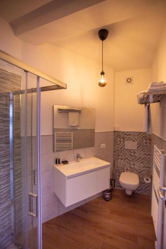 a bathroom with a sink and a toilet at Bed And Breakfast Castello7 in San Felice del Benaco