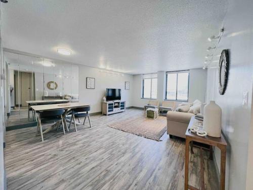 a living room with a couch and a table at The Hartford Skyline - Stylish Downtown Condo with Wifi Gym in Hartford