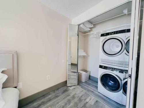 a laundry room with a washer and dryer in it at The Hartford Skyline - Stylish Downtown Condo with Wifi Gym in Hartford