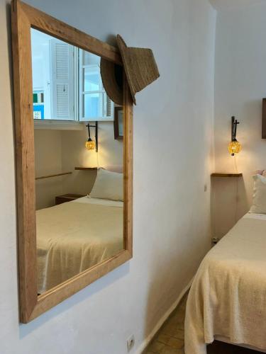 a mirror in a room with two beds at Hôtel Emeraude Essaouira in Essaouira