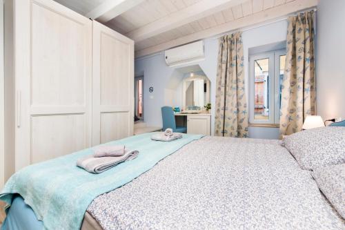 a bedroom with a bed with towels on it at Casa Polo in Rovinj