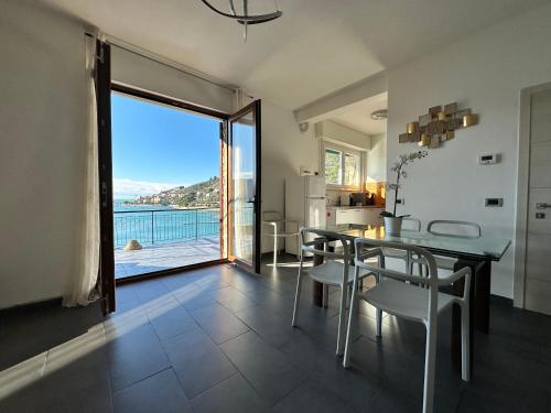 a dining room with a table and a view of the ocean at Profumi di Mare in Portovenere