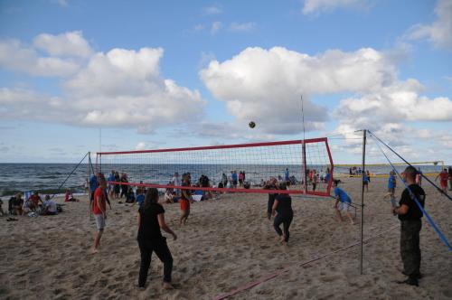 a group of people playing volleyball on the beach at Ośrodek Wypoczynkowy Wielki Błękit in Łukęcin