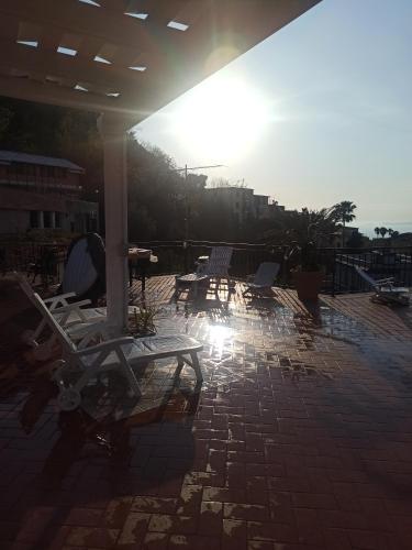 a group of lounge chairs sitting on a patio at La Terrazza Quisisana Sorrento Coast in Castellammare di Stabia