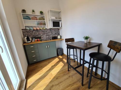 a kitchen with a table and chairs in a room at Hotel Gleis 3viertel Jena in Jena