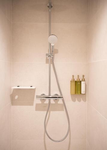 a shower with a shower head in a bathroom at Auberge de la Caillère in Candé-sur-Beuvron
