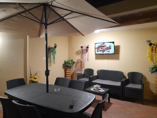 a dining room with a table and chairs and an umbrella at B&B Renella in Caserta
