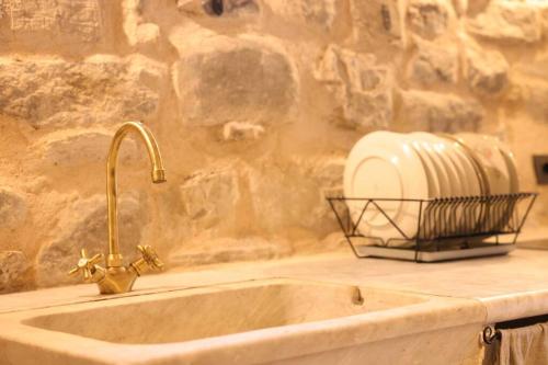 a kitchen sink with a toaster on a stone wall at Villa Maria in Bagnone