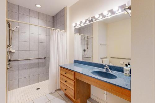 a bathroom with a sink and a shower and a mirror at Bear Trap Dunes - 58A October Glory Ave in Ocean View