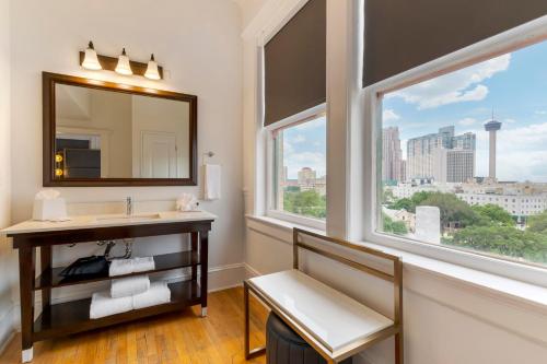 a bathroom with a sink and two windows at Hotel Gibbs Downtown Riverwalk in San Antonio