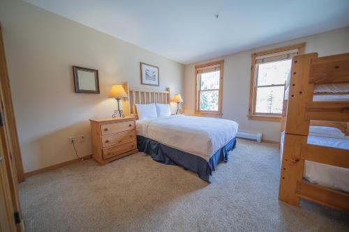 a bedroom with a large bed and two windows at Buffalo Lodge 8327 in Keystone