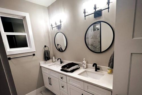 a bathroom with a sink and two mirrors on the wall at 7 Min from Broadway! 3 Bed 2.5 Bath (Sleeps 10+) in Nashville