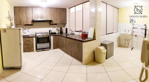 a large kitchen with a refrigerator and a sink at SSAMANA MARÍA APARTMENT 201 in Arequipa