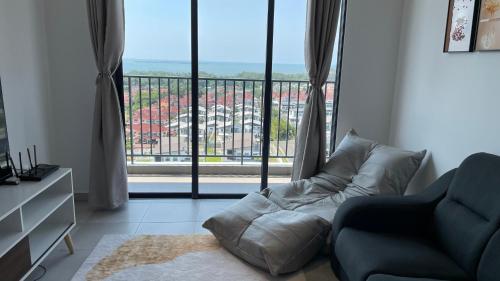 a living room with a couch and a large window at Sandakan Homestay 3BedRoom 2Bath Joyful Cottage 喜悦小屋 For 5 guests in Sandakan