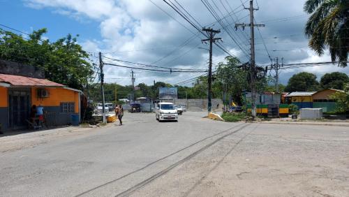 a car driving down a street in a small town at Charming 1-Bedroom House in St Thomas Jamaica in Belfast