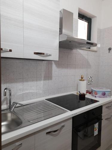 a kitchen with a sink and a counter top at Il Girasole in Caserta