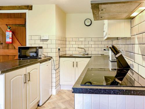 a kitchen with a sink and a counter top at Kite 1 - Uk6549 in Llanfihangel-Bryn-Pabuan