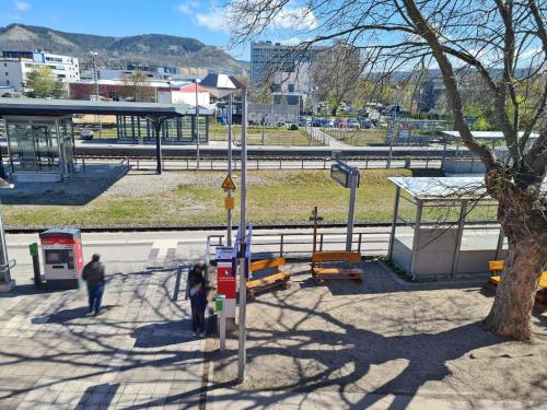 a group of people walking around a bus stop at Hotel Gleis 3viertel Jena in Jena