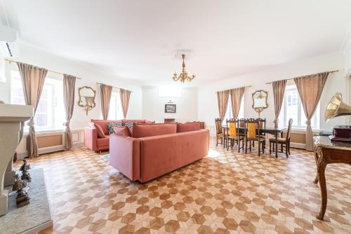 a living room with a pink couch and a table at Old Town - Demini Apartment in Tallinn