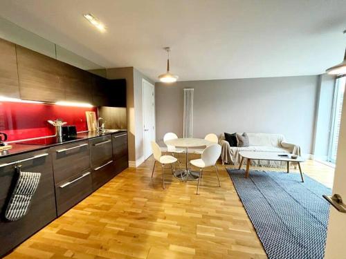 a kitchen with a table and chairs in a room at City Apartment with Terrace in Leicester