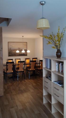 a dining room with a dining table and chairs at Erbgericht Putzkau in Putzkau