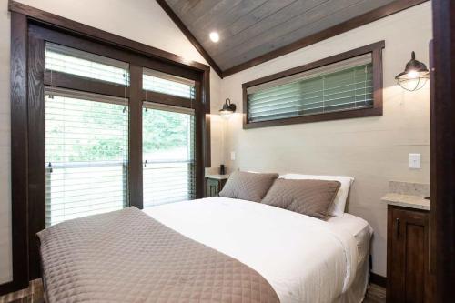 a bedroom with a white bed and a window at Gulf Shores RV Resort in Gulf Shores