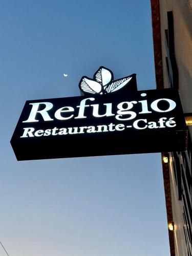 a sign for a retinyl restaurant cafe on the side of a building at Hotel CH in Guadalupe