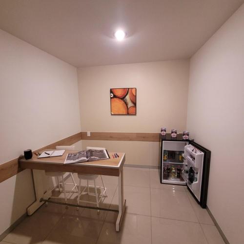 a room with a desk and a small refrigerator at Hotel CH in Guadalupe